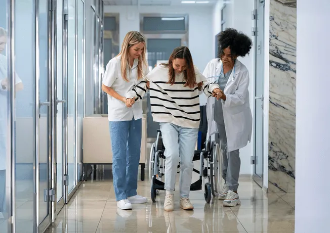 Healthcare professionals assisting patient with hospital to home transition